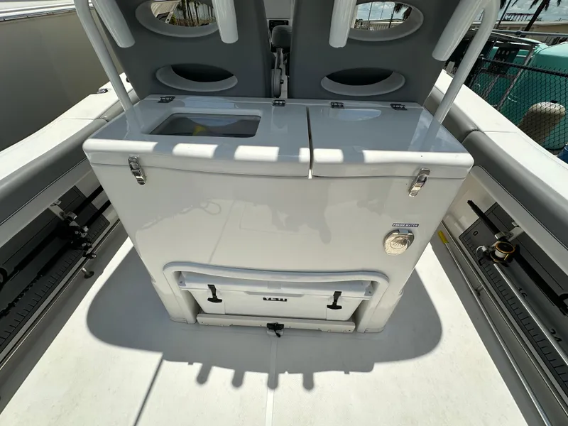 Slide: The Image of 2021 NauticStar 28XS boat interior with storage compartments and seating. - 16