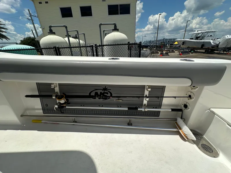 Slide: The Image of 2021 NauticStar 28XS boat interior with fishing rod holder and measuring guide. - 20
