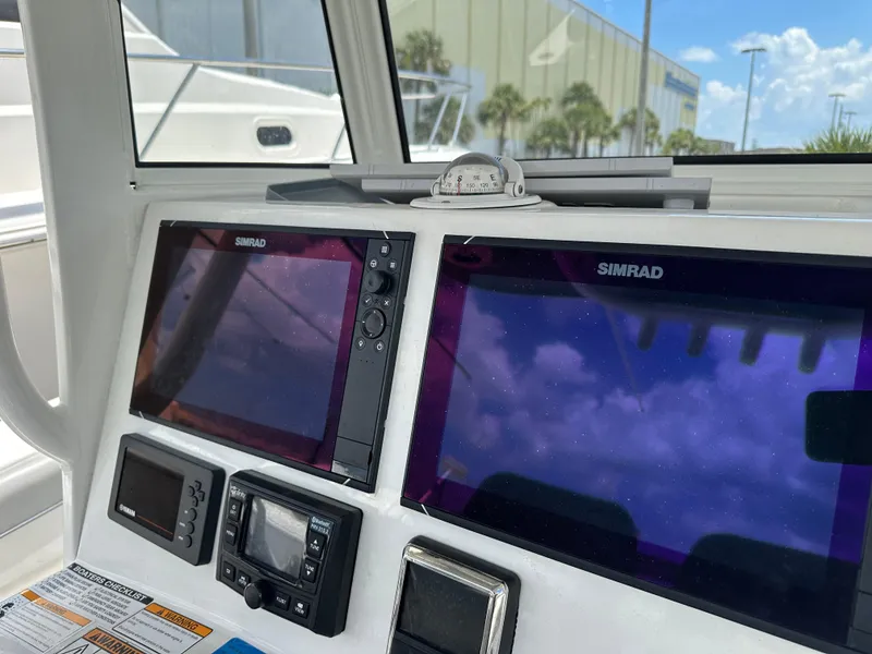 Slide: The Image of Dashboard of 2021 NauticStar 28XS with Simrad navigation displays and compass. - 35