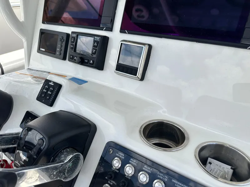 Slide: The Image of Control panel of a 2021 NauticStar 28XS boat with navigation and control systems. - 36