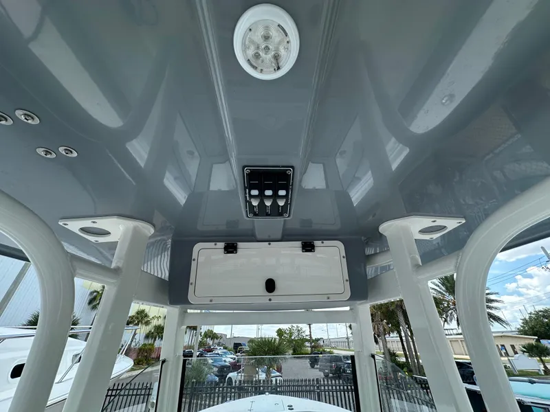 Slide: The Image of 2021 NauticStar 28XS boat interior ceiling with light and control panel. - 46