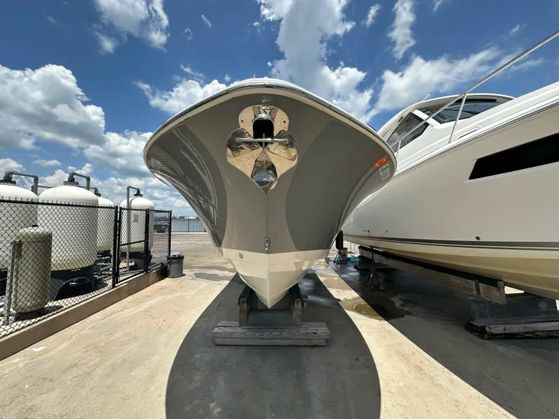Slide: The Image of 2021 NauticStar 28XS boat on dry dock under a bright blue sky. - 5