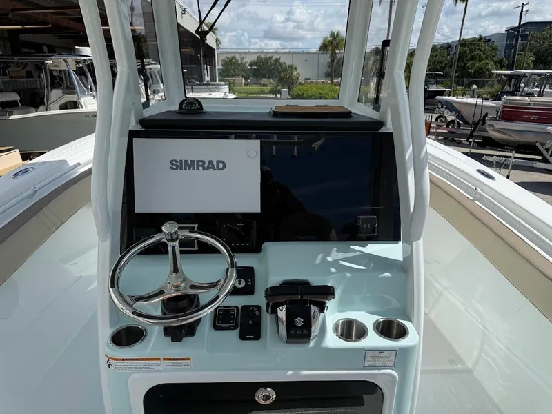 Slide: The Image of 2026 Sea Pro 292 Offshore boat helm with Simrad display and steering wheel. - 11