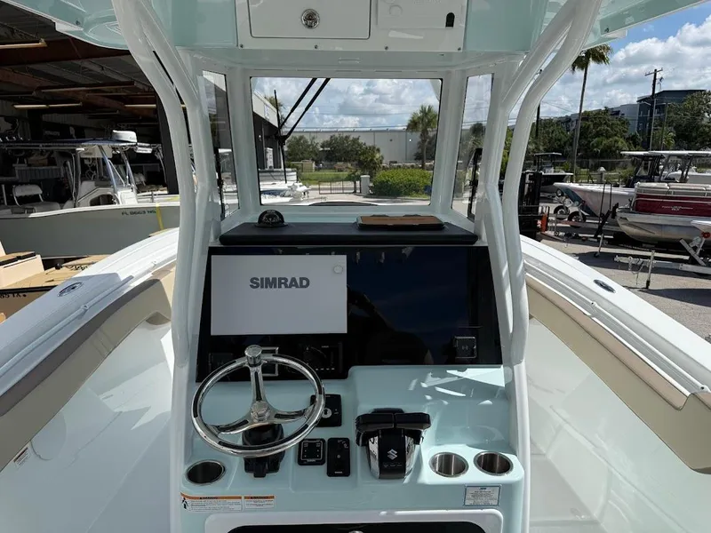 Slide: The Image of 2026 Sea Pro 292 Offshore boat dashboard with Simrad display and steering wheel. - 12