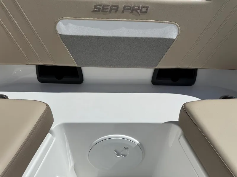 Slide: The Image of 2026 Sea Pro 292 Offshore boat seating area with beige cushions and storage compartment. - 20