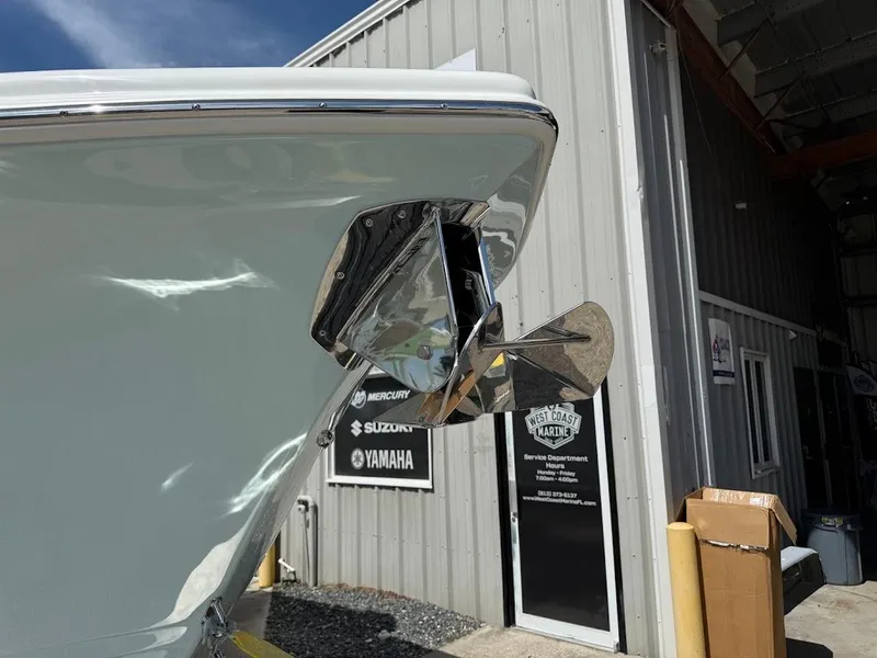 Slide: The Image of 2026 Sea Pro 292 Offshore boat with stainless steel anchor, docked near marine service center. - 3