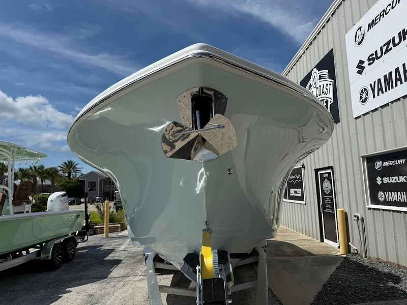 Slide: The Image of 2026 Sea Pro 292 Offshore boat displayed outdoors near dealership signs. - 5