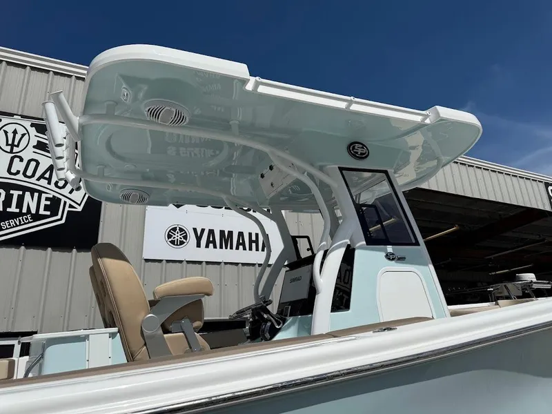 Slide: The Image of 2026 Sea Pro 292 Offshore boat with T-top, parked near Yamaha service center. - 7