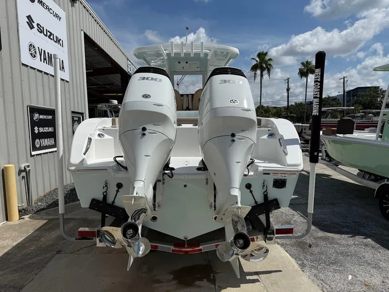 Slide: The Image of 2026 Sea Pro 292 Offshore boat with twin 300 horsepower engines at a marina. - 8