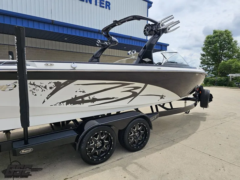 Slide: The Image of 2014 Tigé Z3 boat on trailer, parked outside a building, with custom graphics. - 10