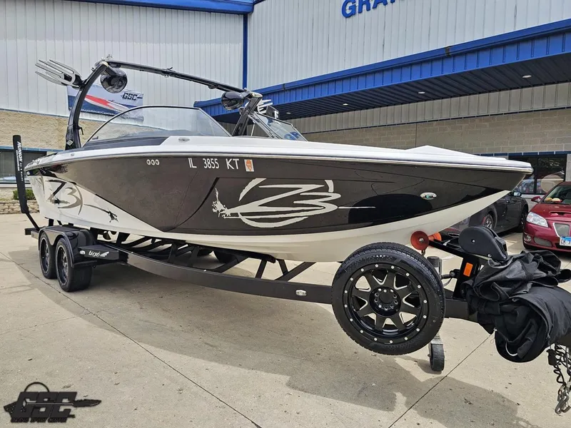 Slide: The Image of 2014 Tigé Z3 boat on trailer, parked outside a building. - 11