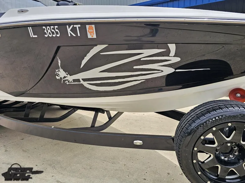 Slide: The Image of 2014 Tigé Z3 boat on trailer with custom graphics and license number IL 3855 KT. - 12