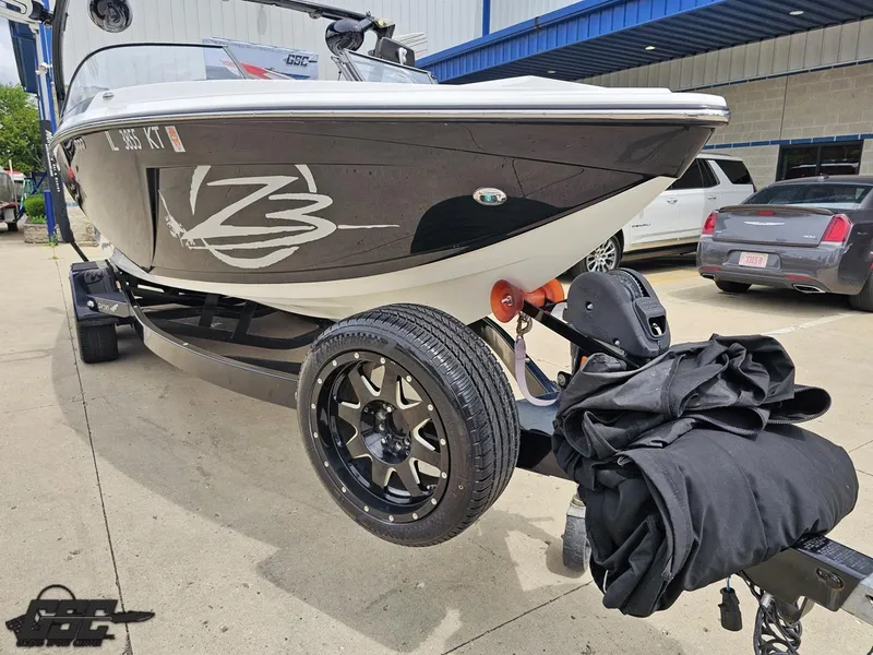 Slide: The Image of 2014 Tigé Z3 boat on trailer, parked outside a building. - 14