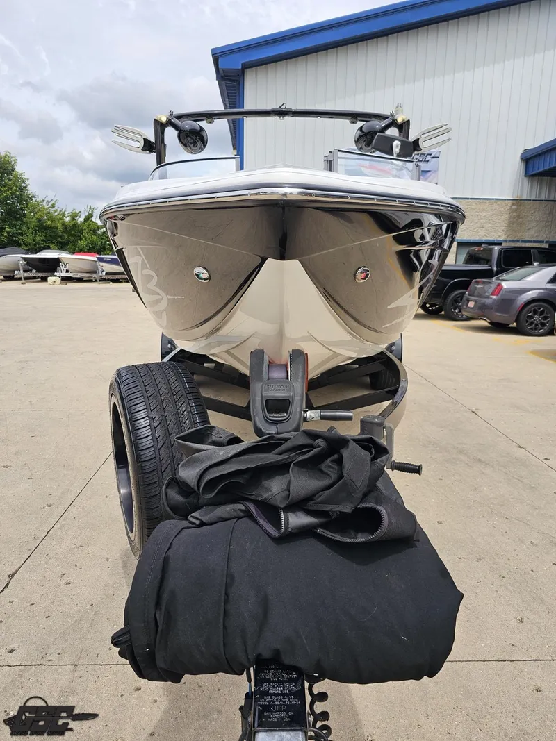 Slide: The Image of 2014 Tigé Z3 boat on trailer, parked outdoors near a building. - 15