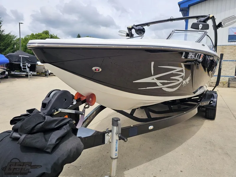 Slide: The Image of 2014 Tigé Z3 boat on trailer, black and white design, parked outdoors. - 18