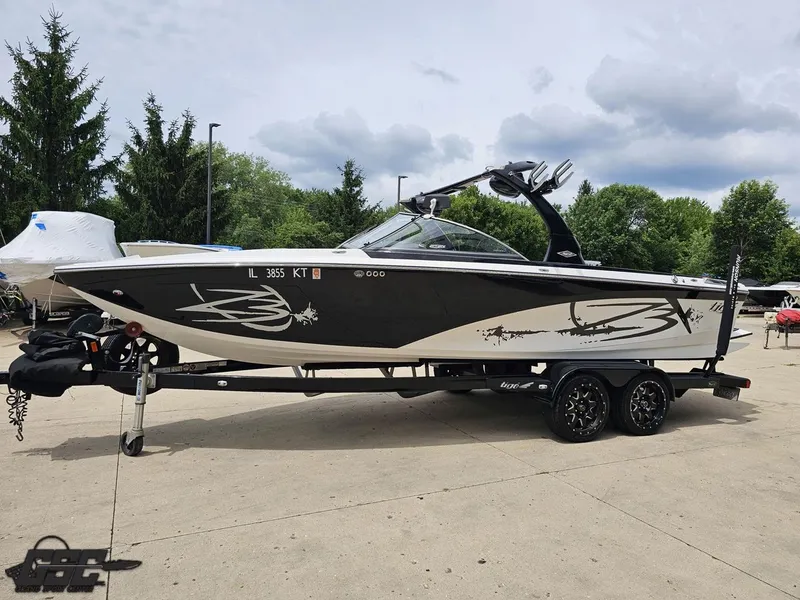 Slide: The Image of 2014 Tigé Z3 boat on trailer, black and white design, parked outdoors. - 20
