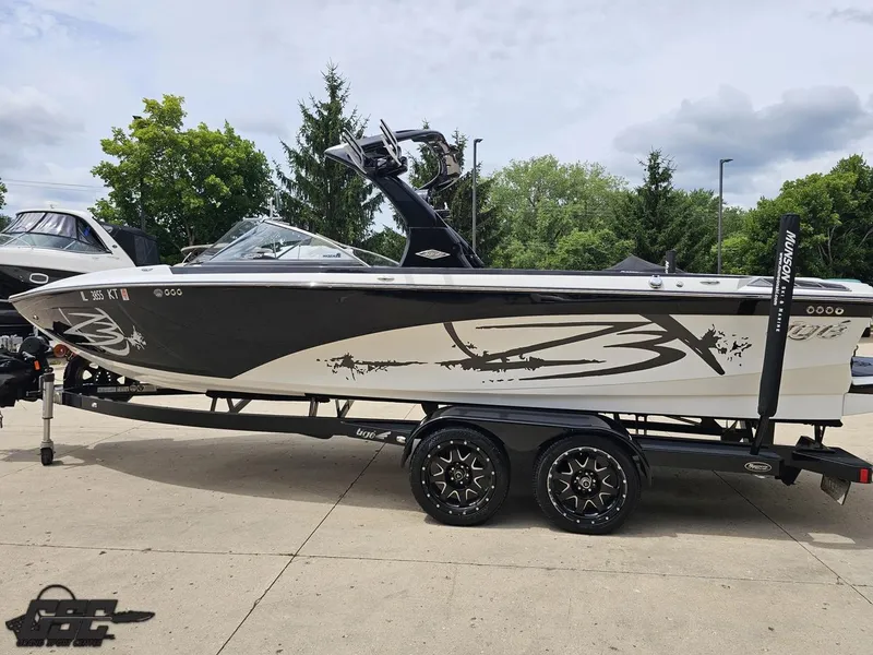 Slide: The Image of 2014 Tigé Z3 boat on trailer, black and white design, parked outdoors. - 25