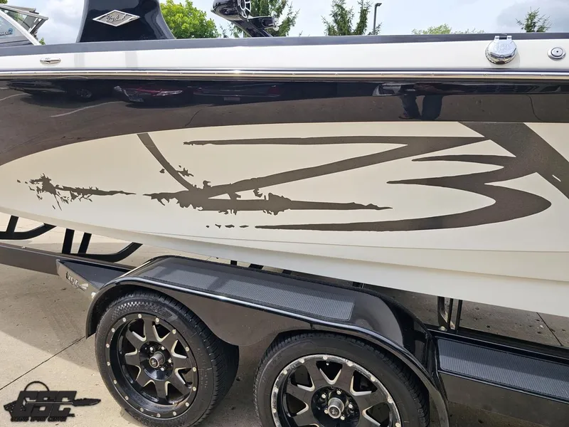 Slide: The Image of 2014 Tigé Z3 boat with custom graphics on a dual-axle trailer. - 26