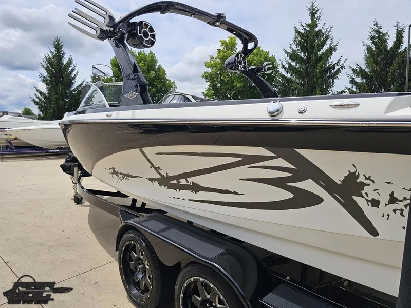 Slide: The Image of 2014 Tigé Z3 boat on trailer, sleek design with custom graphics, parked outdoors. - 27