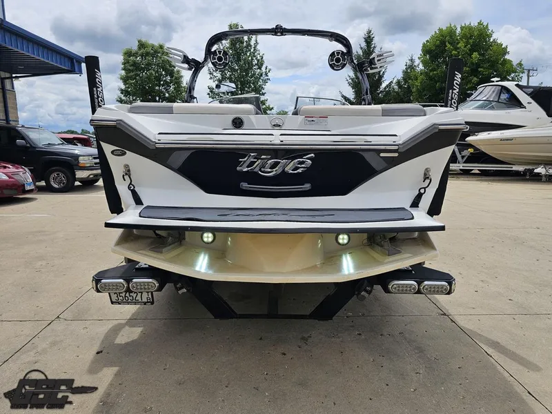 Slide: The Image of 2014 Tigé Z3 boat rear view in a parking lot, showcasing sleek design and features. - 32