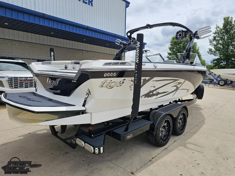 Slide: The Image of 2014 Tigé Z3 boat on trailer, parked outside dealership, showcasing sleek design and graphics. - 35