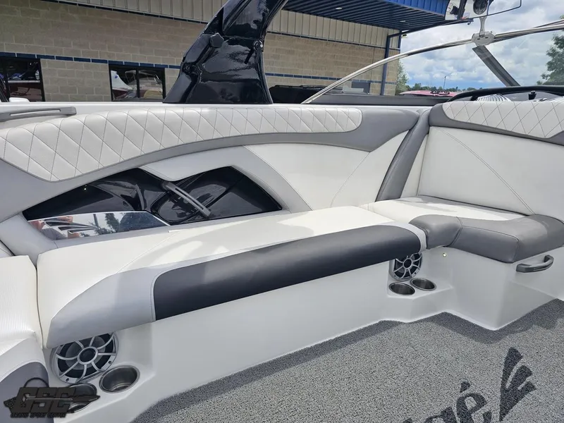 Slide: The Image of 2014 Tigé Z3 boat interior with white and gray seating, cup holders, and speakers. - 46