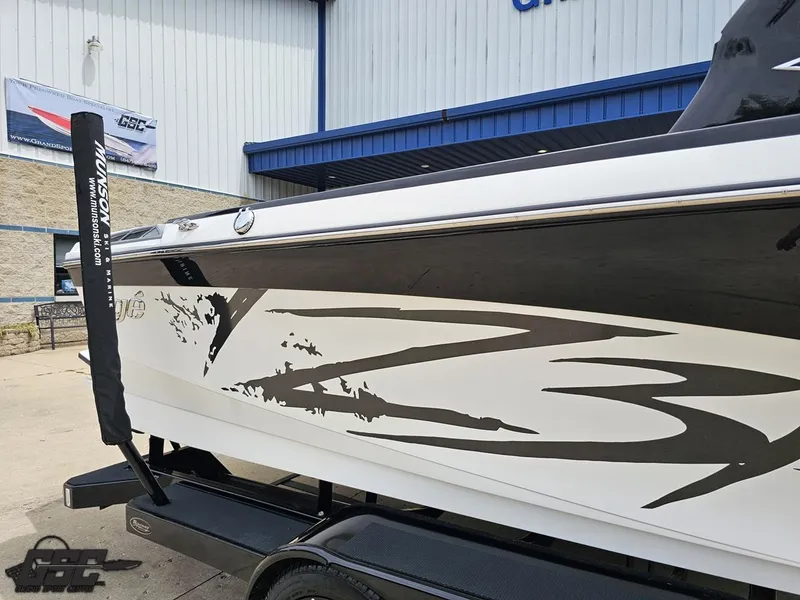 Slide: The Image of 2014 Tigé Z3 boat with sleek graphics on a trailer outside a showroom. - 7