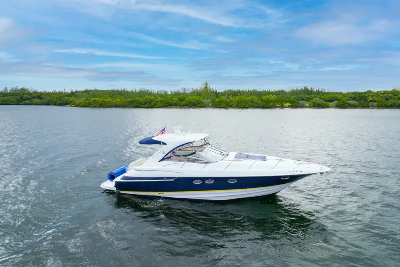 The Image of 2004 Regal 4260 Commodore yacht cruising on a serene lake. - 0
