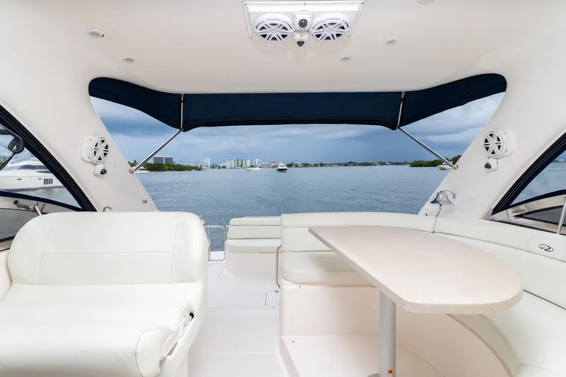 Slide: The Image of Interior view of 2004 Regal 4260 COMMODORE yacht with seating and table, overlooking water. - 11