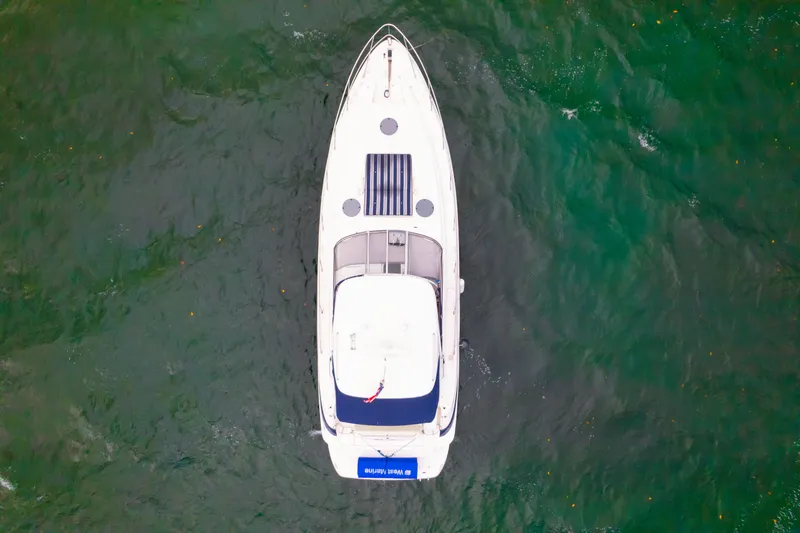 Slide: The Image of Top view of 2004 Regal 4260 Commodore yacht on green water. - 3