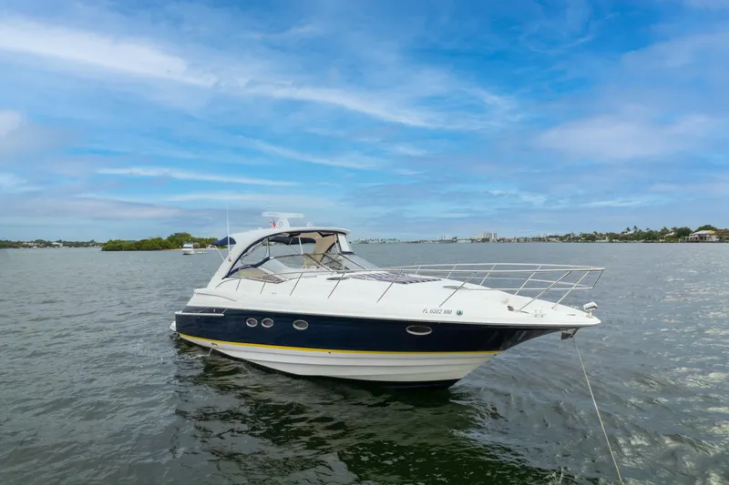 Slide: The Image of 2004 Regal 4260 COMMODORE yacht on calm waters under a blue sky. - 4