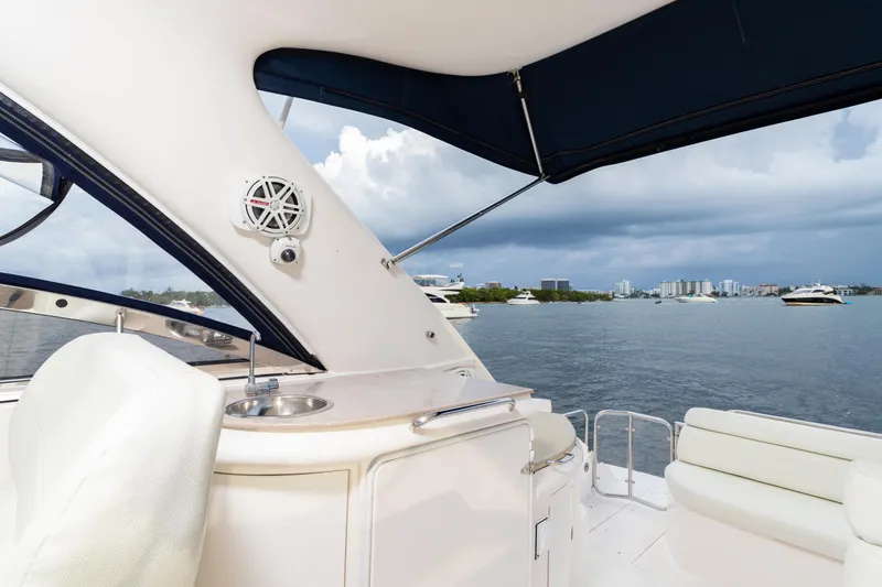 Slide: The Image of 2004 Regal 4260 Commodore yacht interior with sink and seating, overlooking a marina. - 7