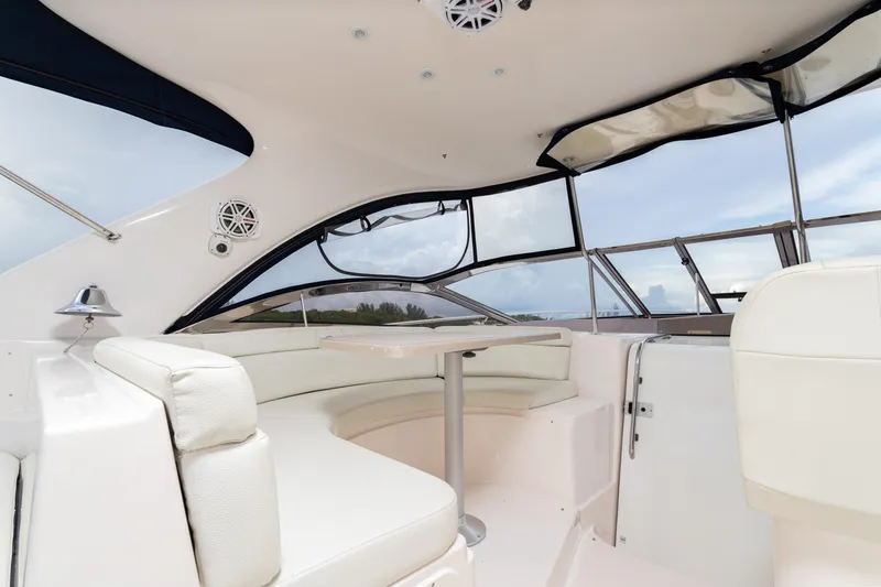 Slide: The Image of 2004 Regal 4260 Commodore yacht interior with white seating and table. - 9