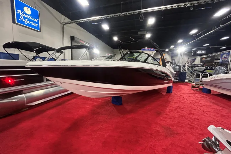 The Image of 2026 Chaparral 23 SSi boat displayed on red carpet at a marine exhibition. - 0