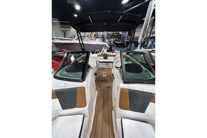 Slide: The Image of 2026 Chaparral 23 SSi boat interior with seating and windshield, displayed indoors. - 5