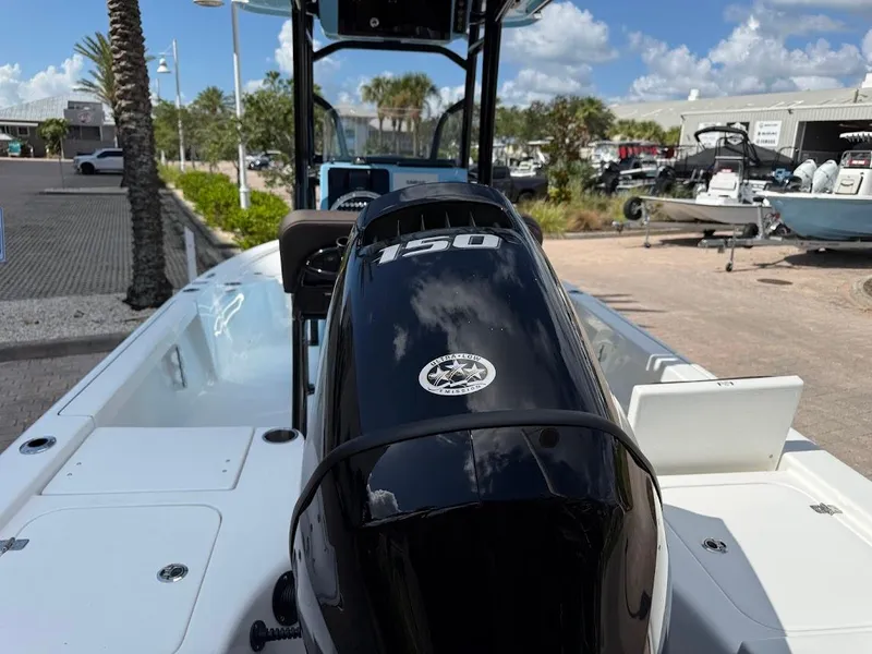 Slide: The Image of 2026 Sea Pro 210 Bay boat with 150 horsepower engine, docked under a sunny sky. - 10