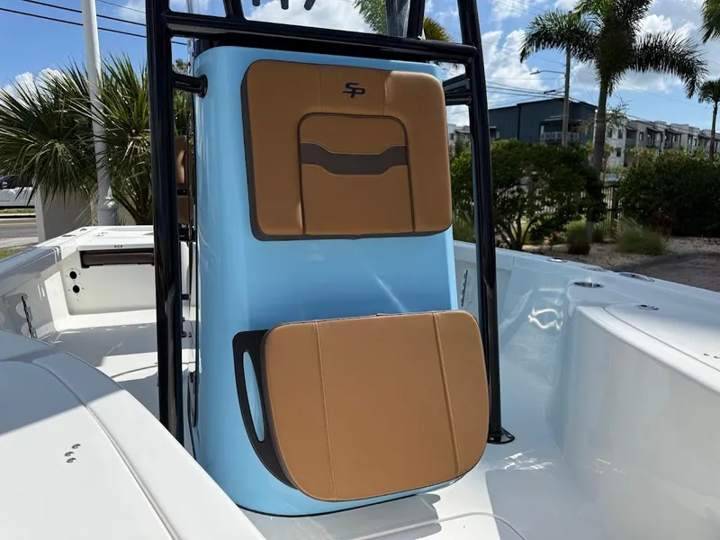 Slide: The Image of 2026 Sea Pro 210 Bay boat interior with tan seating and blue console. - 3