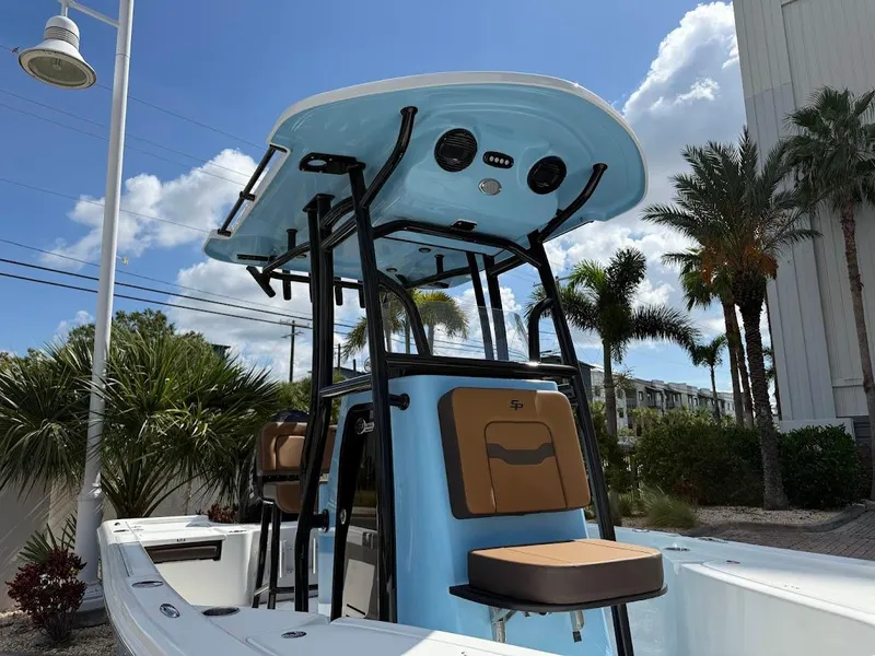 Slide: The Image of 2026 Sea Pro 210 Bay boat with T-top, set against a sunny, palm-lined backdrop. - 5