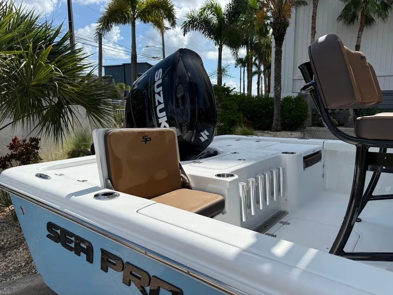 Slide: The Image of 2026 Sea Pro 210 Bay boat with Suzuki engine, surrounded by palm trees. - 8