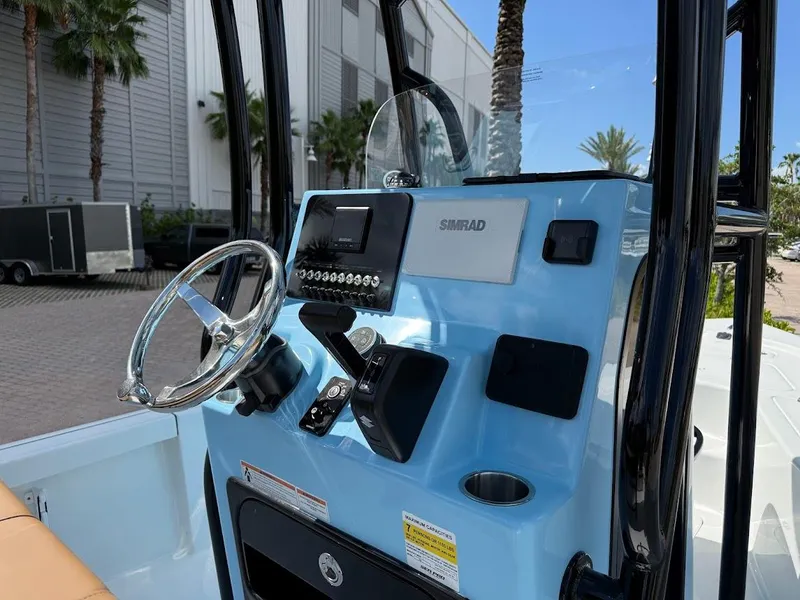 Slide: The Image of 2026 Sea Pro 210 Bay boat console with steering wheel and Simrad display. - 9