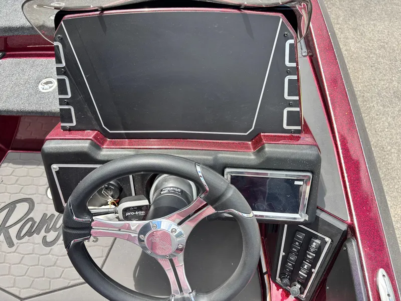 Slide: The Image of 2025 Ranger Z519R boat dashboard with steering wheel and control panel. - 10