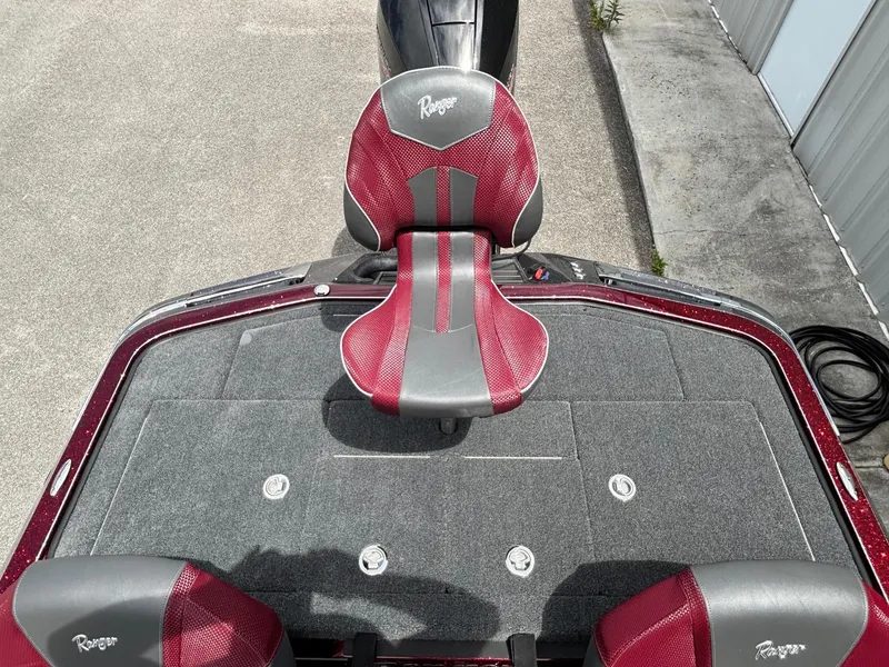 Slide: The Image of 2025 Ranger Z519R boat with red and gray seating, viewed from above. - 11