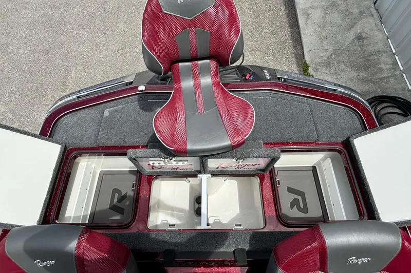 Slide: The Image of 2025 Ranger Z519R boat interior with red seats and storage compartments. - 12