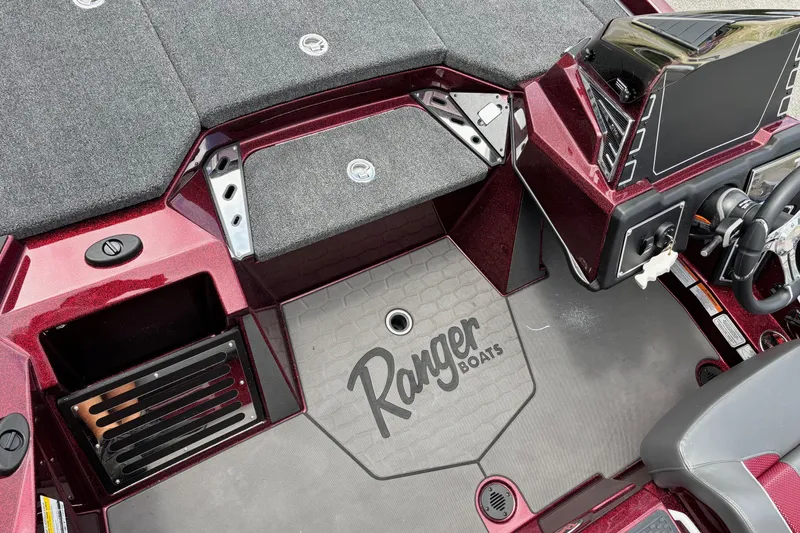 Slide: The Image of 2025 Ranger Z519R boat interior with steering console and branded flooring. - 7