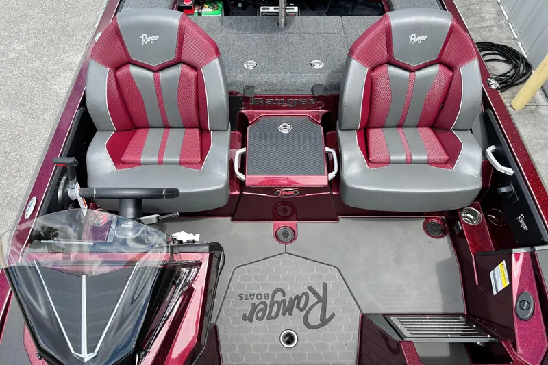 Slide: The Image of 2025 Ranger Z519R boat interior with red and gray seats, steering wheel, and logo. - 8