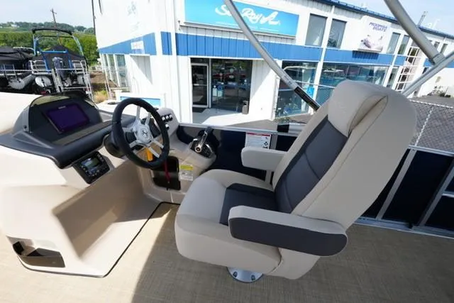 Slide: The Image of 2026 Harris Cruiser 230 boat helm with modern steering and comfortable captain's chair. - 11