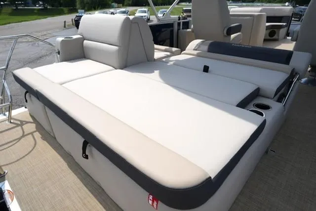Slide: The Image of 2026 Harris Cruiser 230 boat with spacious beige seating and cup holders. - 14
