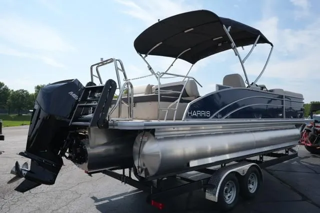 Slide: The Image of 2026 Harris Cruiser 230 pontoon boat on trailer, featuring a sleek design and powerful outboard motor. - 4