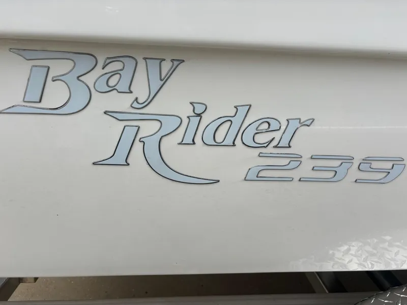 Slide: The Image of Bay Rider 239 Bay 2026 model logo on boat exterior. - 16