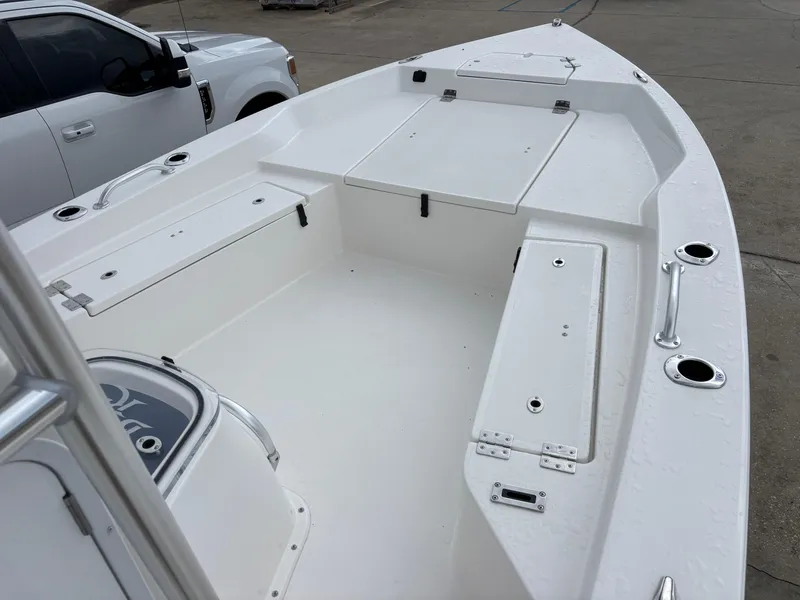 Slide: The Image of 2026 Bay Rider 239 Bay boat interior with storage compartments and fishing rod holders. - 19